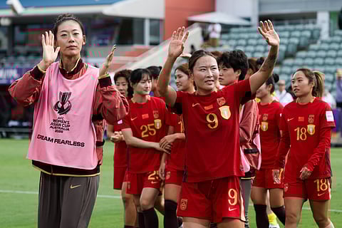 Team China acknowledges the crowd after winning over Taiwan