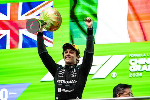 Kimi Antonelli poses with the trophy