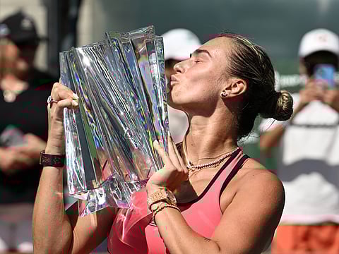Aryna Sabalenka kisses the championship trophy
