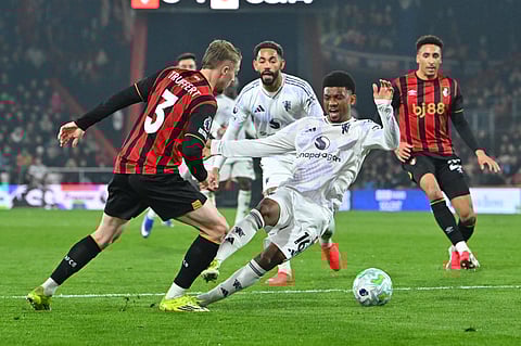Amad Diallo goes down after a challenge by Adrien Truffert in the penalty area