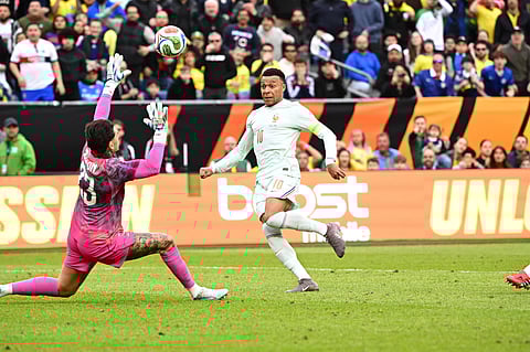 Kylian Mbappe chips over Ederson to put France ahead