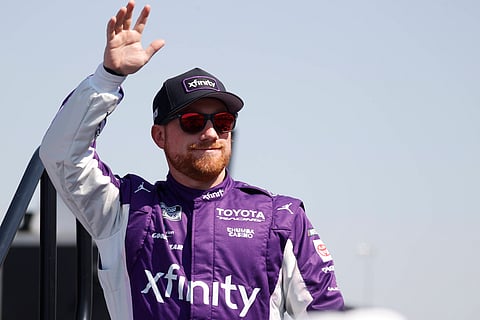 Tyler Reddick waves to the fans