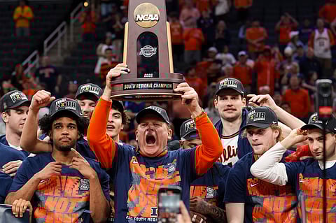 Illinois Fighting Illini head coach Brad Underwood holds the NCAA trophy