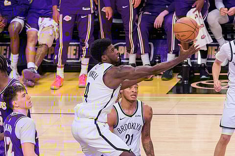 Drake Powell reaches for a lose ball