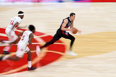 Duncan Robinson of Detroit Pistons drives forward with the ball