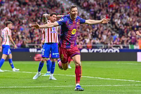 Robert Lewandowski celebrates after netting the winning goal against Atletico Madrid