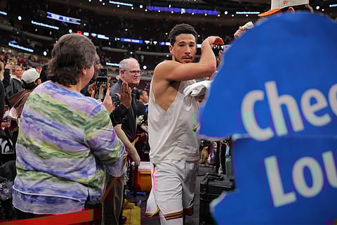 Devin Booker shake hands with fans post-match