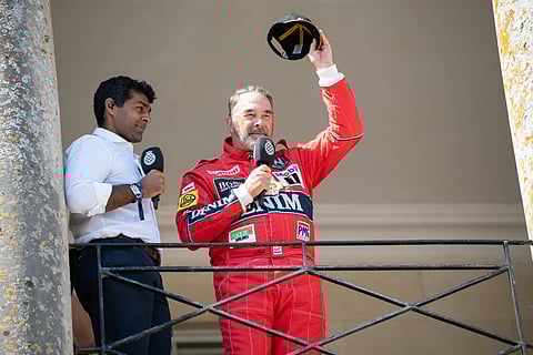 Nigel Mansell waves at the fans