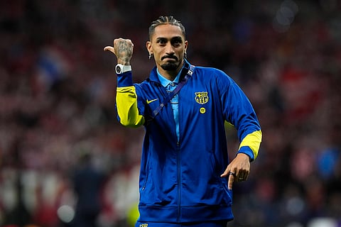 Raphinha gestures at the Atletico Madrid fans at full-time