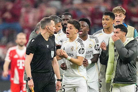 Real Madrid players protesting to the referee over the red card incident