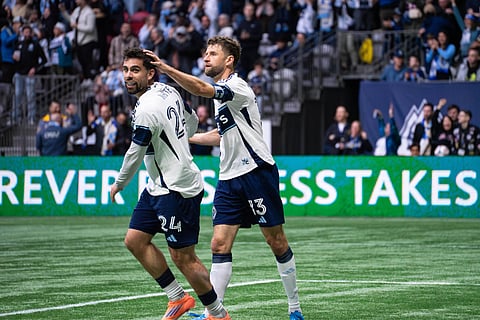 Brian White of Vancouver Whitecaps with Thomas Muller