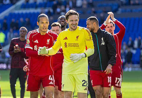 Virgil van Dijk pushes Freddie Woodman to celebrate with the fans