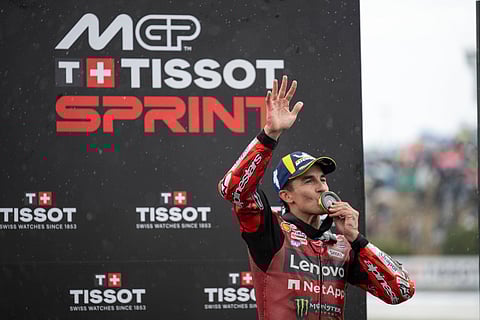 Marc Marquez kisses the medal while waving at the crowd