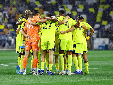 Nashville SC starting XI during team huddle