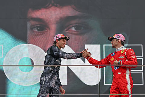 Charles Leclerc shakes hands with Kimi Antonelli