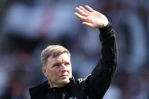 Eddie Howe applauds the fans at full-time