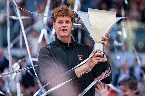 Jannik Sinner poses with the trophy