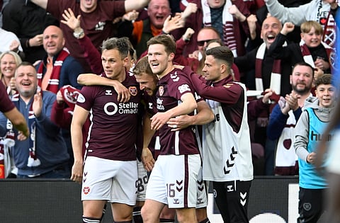 Hearts players celebrate a goal with the fans