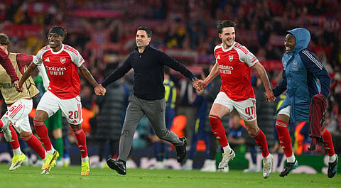 A celebratory image of Arsenal coach and players