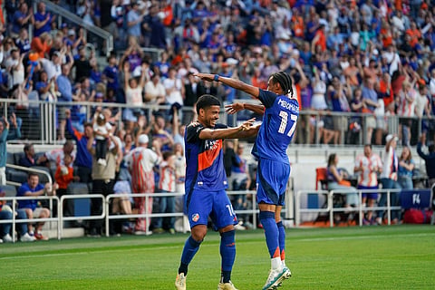 Evander celebrates his goal with teammate Kenji Mboma Dem
