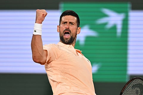 Novak Djokovic celebrates his win in the French Open first round