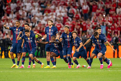 PSG players celebrate after they beat Arsenal on penalties