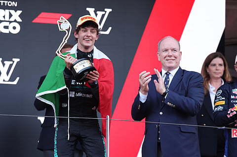 Kimi Antonelli poses with the winner's trophy