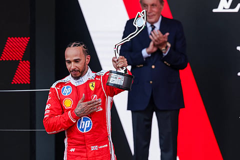 Lewis Hamilton poses with the runner-up trophy