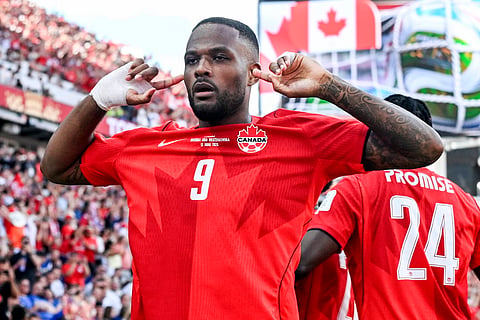 Cyle Larin celebrates after scoring the equaliser against Bosnia and Herzegovina