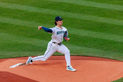 Bryan Woo throws a pitch during an MLB game
