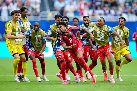 Kevin Pina celebrates with teammates after scoring Cape Verde's first-ever goal at the World Cup