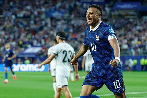 Kylian Mbappe celebrates his goal against Iraq