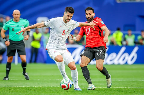 Iran and Egypt players compete for the ball during their tie in Seattle