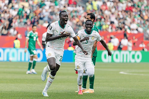 Papa Gueye celebrates his goal against Iraq