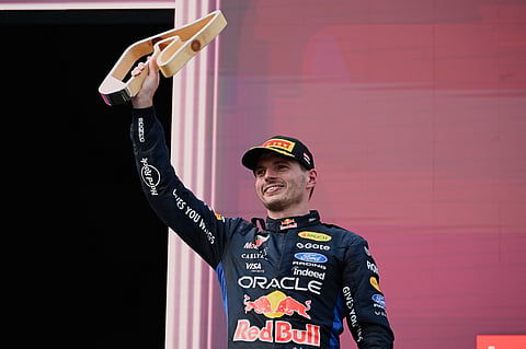 Max Verstappen poses on the podium