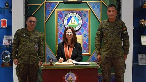 ZAMBOANGA. Australian Ambassador Hae Kyong Yu (seated) signs the visitor’s logbook during the visit at the Western Mindanao Command headquarters in Camp Navarro, Calarian, Zamboanga City. Yu reiterated the promise of Australia to extend assistance to the Armed Forces of the Philippines (AFP), particularly the Western Mindanao Command, in the fight against terrorism. 
