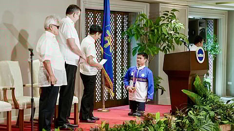 CASH BONUS. Dabawenyo Paralympian swimmer Ernie Gawilan receives a P2.4 million cash incentive from President Ferdinand Marcos Jr. for his exemplary performance in the 4th Asian Para Games in Hangzhou, China, where he clinched one gold medal and one bronze, during an awarding ceremony at the Heroes Hall in Malacañang.