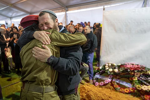 Mourners attend the funeral of reservist Gavriel Shani during his funeral at Mt. Herzl military cemetery in Jerusalem, Wednesday, Jan. 31, 2024. Shani, 28, was killed during Israel's ground operation in the Gaza Strip, where the Israeli army has been battling Palestinian militants in the war ignited by Hamas' Oct. 7 attack into Israel.