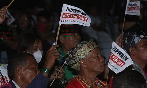 'FILIPINOS ARE NOT FOR SALE.' Members of the indigenous peoples (IP) raised their flaglets with the text "Filipinos are not for sale" during the "Unity for One Nation, One Prayer," at the San Pedro Square on San Pedro Street in Davao City on January 28, 2024. Attendees opposed the charter change (Cha-cha), which would amend the 1987 Philippine Constitution. Critics say that it would have dire consequences, such as abuse in political power.