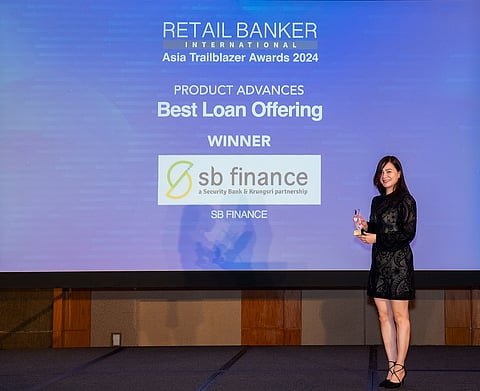 SB Finance Head of Corporate Employee Loan Business Jasmin Ga-a receives Best Loan Offering trophy from the 15th Retail Banker International Awards in Singapore.