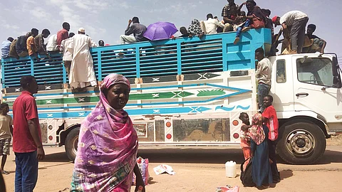 People board a truck as they leave Khartoum, Sudan, on June 19, 2023. 