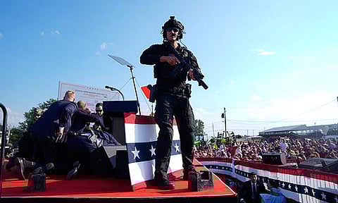 Republican presidential candidate former President Donald Trump is surrounded by U.S. Secret Service agents on stage at a campaign rally, Saturday, July 13, 2024, in Butler, Pennsylvania.
