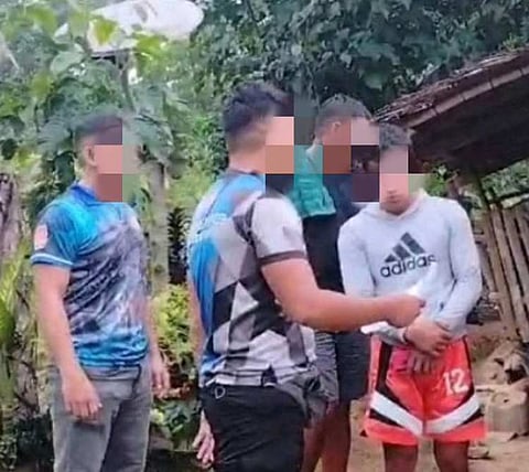 ZAMBOANGA. Lawmen arrest in a law enforcement operation two of the most wanted persons in Purok Bagong Silang, Sanito village, Ipil, Zamboanga Sibugay on Wednesday, July 10. A photo handout shows policemen reading the rights to one of the wanted persons they have arrested.