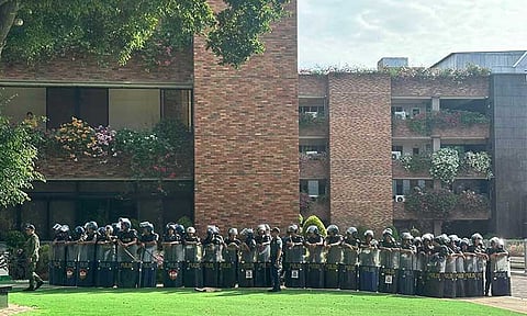 HUMAN BARRICADE. A human barricade was formed on Tuesday, September 3, by the Philippine National Police (PNP) personnel after members of the media along with Atty. Israelito Torreon, legal counsel for the Kingdom of Jesus Christ (KOJC), attempted to enter the site of an alleged drilling activity by police at Jose Maria College (JMC), despite a temporary protection order (TPO) served on August 28.