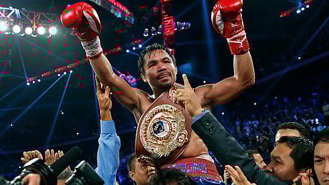 MACAU. Manny Pacquiao from the Philippines wears the champion's belt after defeating Brandon Rios of the United States in their WBO international welterweight title fight Sunday, November 24, 2013, in Macau. Pacquiao defeated Rios by unanimous decision.