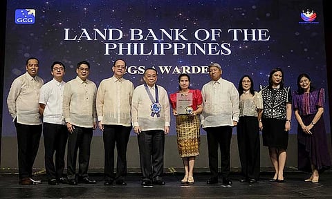Director Virginia N. Orogo (5th from right) accepts the award on behalf of LANDBANK for being the top GOCC in corporate governance for 2023 from Executive Secretary Lucas P. Bersamin (6th from right), GCG Chairperson Atty. Marius P. Corpus (7th from right), and GCG Commissioners Atty. Brian Keith F. Hosaka (8th from right) and Atty. Geraldine Marie Berberabe-Martinez (rightmost) during the 2024 GCG Awards Ceremony on 25 November 2024 at the PICC Complex in Pasay City. Joining them are LANDBANK Executive Vice President Liduvino S. Geron (4th from right), Senior Vice President Atty. Roderick P. Sacro (leftmost), and Vice Presidents Atty. Myra-Lyn S. Peñalosa (3rd from right), May D. Arizabal (2nd from right), and Atty. Nikkolas G. Tolentino (9th from right).
