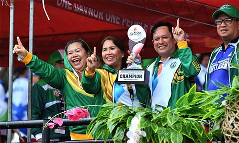 HAIL THE CHAMPS. Department of Education (DepEd) Davao City Superintendent Reynante Solitario raises the overall championship trophy during the rain-soaked Davao Region Athletic Association (Davraa) Meet 2025 closing ceremony on Saturday afternoon, March 14, at the Davao del Norte Sports and Tourism Complex.