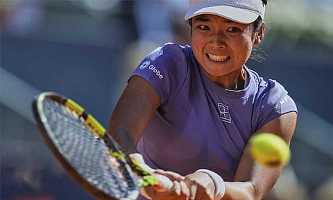 Philippines' Alexandra Eala returns the ball during her match against Poland's Iga Swiatek at the Madrid Open tennis tournament in Madrid, Spain, Thursday, April 24, 2025.