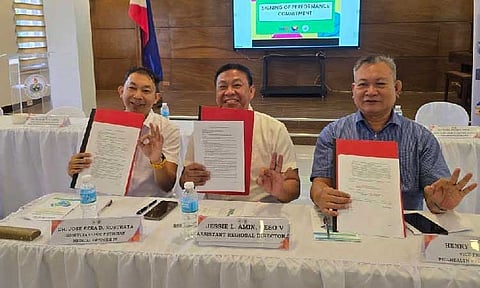 PARTNERSHIP. Konsulta Clinic Physician Medical Officer Jose Ezra Rostrata (left), Department of Education (DepEd) Assistant Regional Director Jessie Amin (middle), and Philippine Health Insurance Corporation Region III Acting Vice President Henry Almanon (right) sign the commitment agreement establishing the Konsulta provider clinic of the DepEd regional office in Central Luzon—the first of its kind among DepEd regional offices nationwide. (Photo courtesy of PhilHealth)