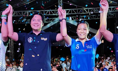 Defeated Davao City mayoral and first district congressional bets Karlo and Migs Nograles raise their hands during their miting de avance near Diho Subdivision in Buhangin District on the final day of the campaign, Saturday, May 10, 2025.
